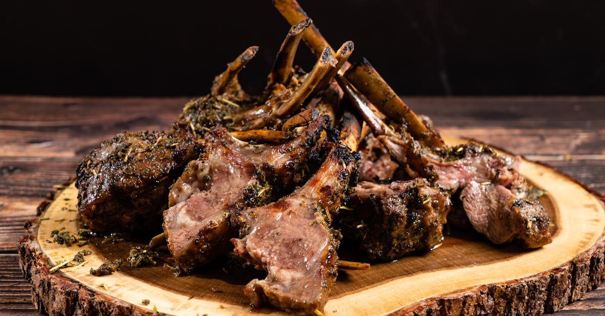 Delicious herb-crusted lamb chops on a rustic wood platter, perfect for elegant dining.